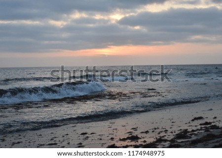 Laguna Beach: California waves crashing into the beach as the sun begins to set.