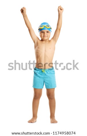 Full length portrait of a boy wearing swimming trunks holding his hands up isolated on white background Royalty-Free Stock Photo #1174958074