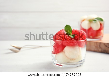 Bowl with melon and watermelon balls on table. Background with space for text