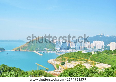 The beautiful blue sky, blue sea water and the view of the city life on the island.