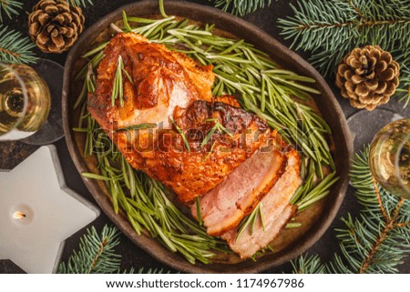 Baked Christmas pork (ham) with rosemary. Christmas background, top view.