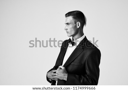 gray picture of a man in a suit side view                             