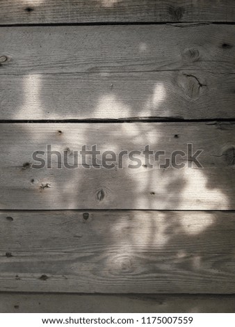 old gray boards with cracks and sunlight