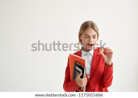 surprised woman with a coin in her hand and a folder with documents                             