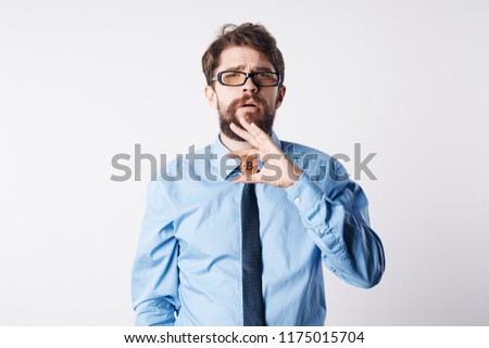 puzzled look a man with glasses and a coin in his hand                           