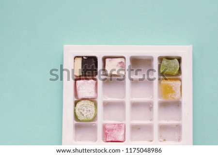 Traditional turkish delight  on blue background.  Arabic traditional dessert rahat lukum in a box. 