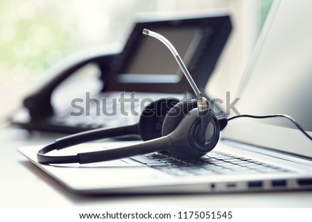 VOIP headset headphones telephone and laptop concept for communication, it support, call center and customer service help desk Royalty-Free Stock Photo #1175051545