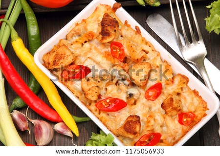 Casserole with chicken and hot pepper in white bowl