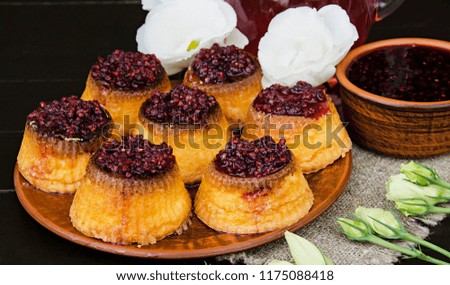 Cupcakes with raspberry jam on a brown plate. Dessert for the beloved.