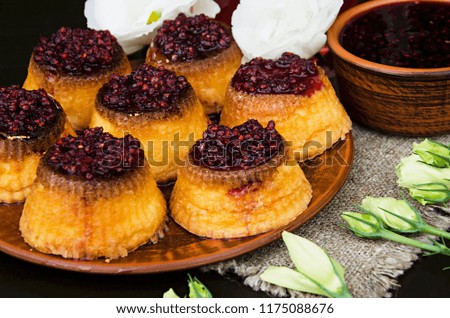 Cupcakes with raspberry jam on a brown plate. Dessert for the beloved.