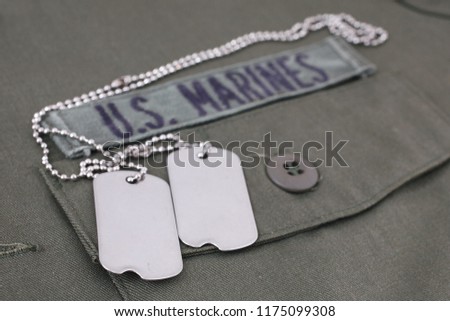 U.S. MARINES Tape with dog tags on olive green uniform background