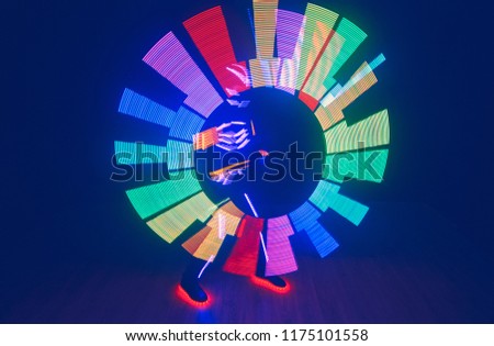 Dancer in suit with LED lamps. Night club party.
