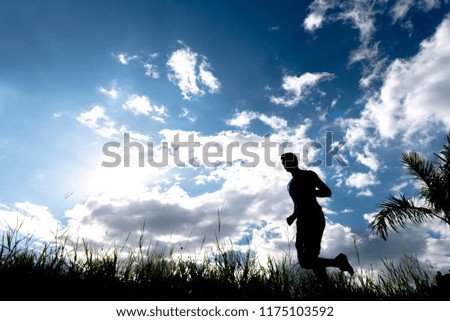 Men running outdoor on silhouette background.