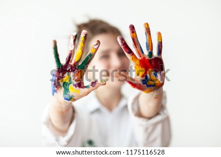 Happy woman showing hands painted in colorful paints on white background. Fun concept