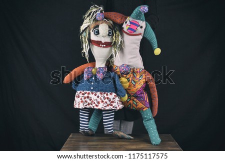 Couple, two puppets hugging on dark background