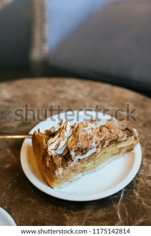 apple pie and swiss meringue, on brown marble table in the cafeteria