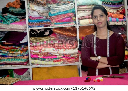Portrait of woman with arms crossed in boutique, small business owner Royalty-Free Stock Photo #1175148592