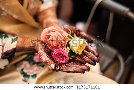 Indian Pakistani Bride Showing her mehndi  and some beautiful roses