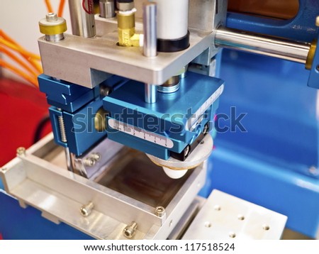 Closeup of printng machine working part with white light