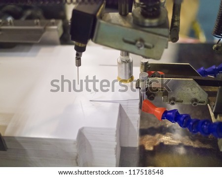 Closeup of printng machine working part with white light