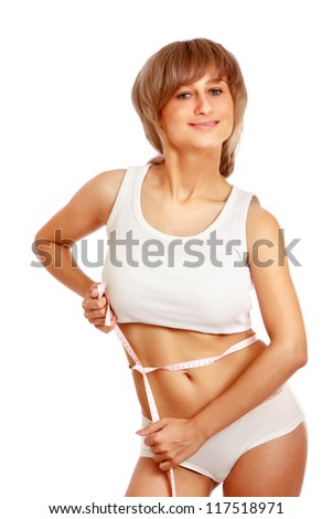 Young girl measuring waist on white background