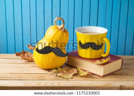 Autumn and Movember concept with coffee cup , pumpkin squash and mustache on wooden background