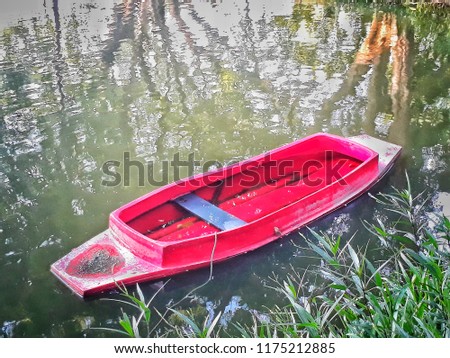 Old red boat parked, waiting to use during the flood. And focus only on the point in the picture