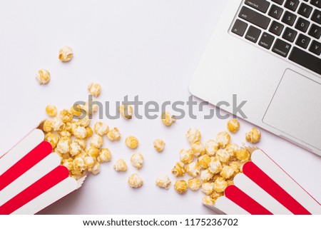 Glasses and popcorn with keyboard on a white background top view