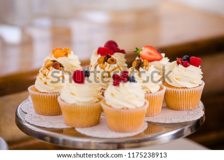 Candy bar with sweet cakes and decor items in bright colors.