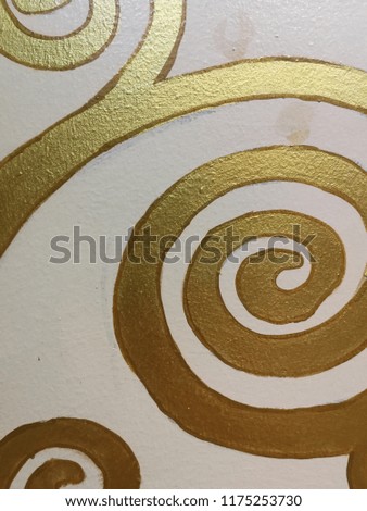 Golden swirling curves decoration paint on wall 