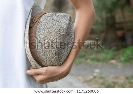 Boy holding straw hat