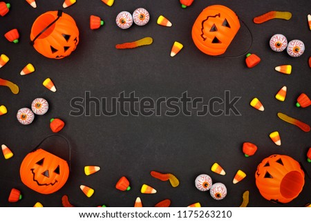 Halloween candy frame over a dark black background. Copy space.