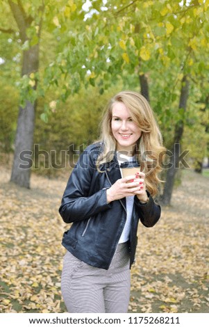 Pretty Young Woman Walking in Autumn Park Relax Leisure Black Leather Jacket Fashion Modern Red Nails Drinking Coffee Take Away Cup