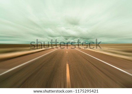 Long desert highway in Arizona with motion blur. Royalty-Free Stock Photo #1175295421