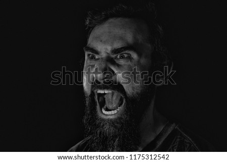 Angry man looking forwards screaming