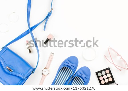 Blue flats, cosmetics, purse and sunglasses overhead.