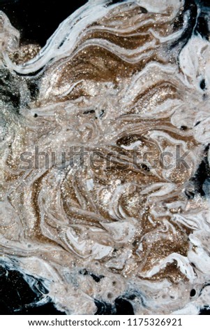 Creative background with abstract golden waves. Liquid paint. Mineral texture. Black, White and Golden Royalty-Free Stock Photo #1175326921
