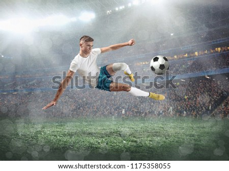 Soccer player on a football field in dynamic action at summer day under sky with clouds. Sporty man is shooting the ball outdoor.