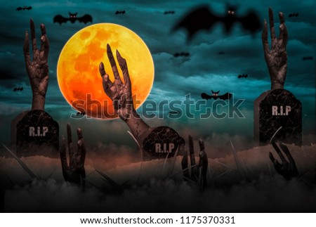Halloween Horror,  moon is full of scary. On day release of ghost, with zombie hand emerging from grave in  graveyard, atmosphere full of fog and languor, and sky is full of bats (photo manipulation)