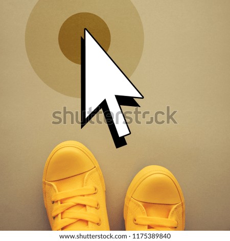 Sneakers and mouse cursor arrow, top view
