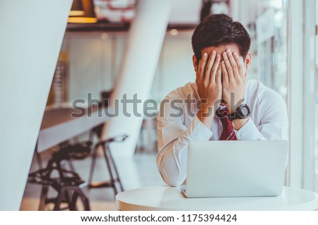 Businessmen feel stressed and tired sitting at his office with a laptop,mobbing concept Royalty-Free Stock Photo #1175394424