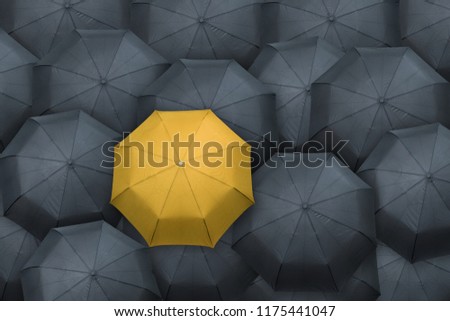 Yellow umbrella stand out from the crowd. Leader concept. Royalty-Free Stock Photo #1175441047