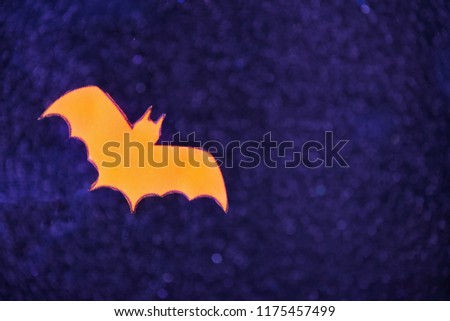 Halloween background with flying paper bats on front and shiny sparkle bokeh light