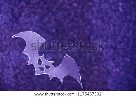 Halloween background with flying paper bats on front and shiny sparkle bokeh light