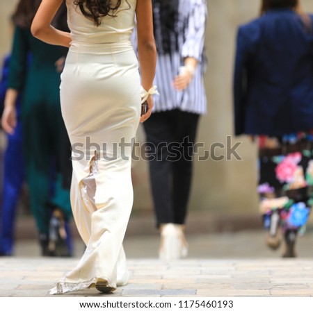 girl from behind in a long white dress