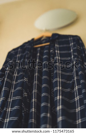 Blue Shirt with Stripes Hanging on the Wall in the Living Room - Isolated Object, Partly Blurred, Vintage Film Edit