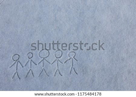Painted by child five primitive little men holding hands. Picture on the snow. Happy winter season.