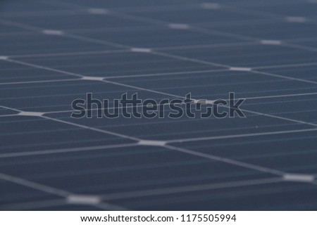 Low angle photo of the surface of a solar panel that produces electricity directly from the sunlight.