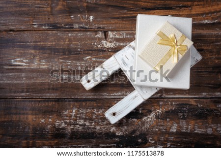 Old wooden toy sled with gift boxes on  wooden background. Top View Flat Lay Group Objects
