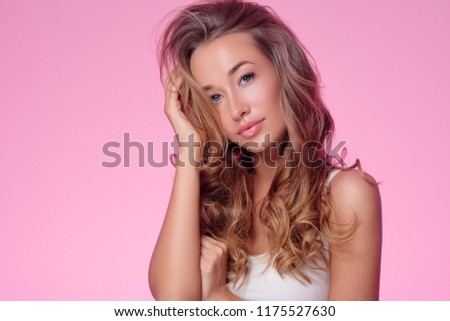 Beauty Woman face Portrait. Beautiful Spa model Girl with Perfect Fresh Clean Skin.  female looking at camera  on pink   background. Beautiful hairstyle Youth and Skin Care Concept